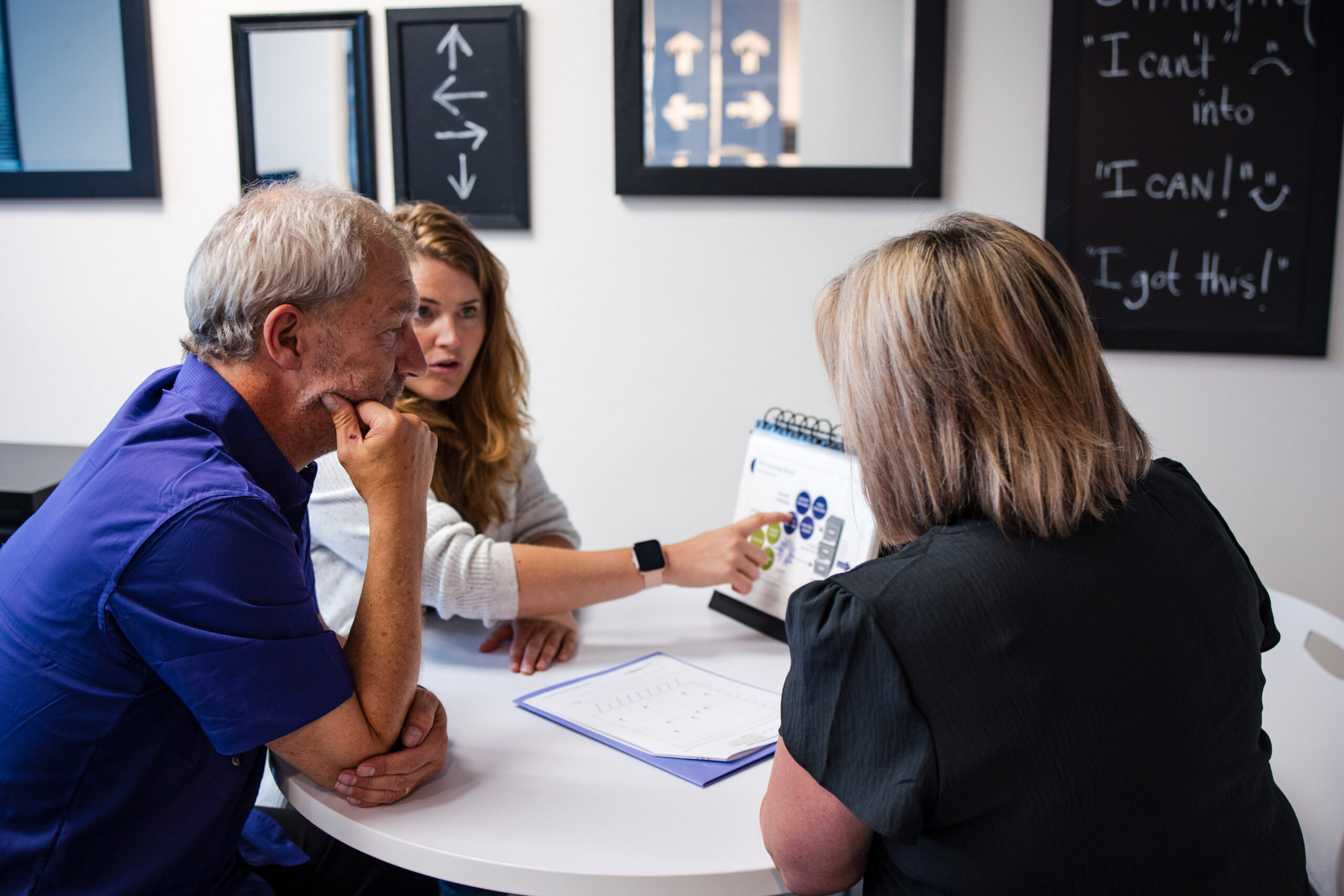 A franchisee walks parents through the results of their child's cognitive assessment.